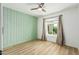 Bright bedroom features a wood-look floor, window and a ceiling fan at 18820 N 33Rd Ave, Phoenix, AZ 85027
