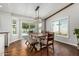 Bright dining area with wooden table and bench seating, light fixture, and sliding doors to the pool at 18820 N 33Rd Ave, Phoenix, AZ 85027
