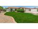 Beautiful front yard features lush lawn, charming brick accents, and a well-maintained landscape at 18820 N 33Rd Ave, Phoenix, AZ 85027