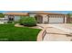 Charming home exterior featuring a well-manicured lawn, arched entry and attached two-car garage at 18820 N 33Rd Ave, Phoenix, AZ 85027