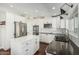 Bright kitchen featuring white cabinetry, an island, stainless steel appliances, and sleek dark countertops at 18820 N 33Rd Ave, Phoenix, AZ 85027