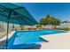 Pool and backyard features a deck and an umbrella for shade at 18820 N 33Rd Ave, Phoenix, AZ 85027