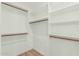 Walk-in closet with built-in shelving and wooden rods at 18820 N 33Rd Ave, Phoenix, AZ 85027