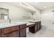 Bathroom with double sinks, spacious countertops, tile flooring, and a large mirror at 2000 N 36Th St # 17, Phoenix, AZ 85008
