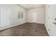 A bedroom with neutral walls and tile floors, two interior doors and one window with bright-white trim at 2000 N 36Th St # 17, Phoenix, AZ 85008