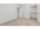 Bright bedroom with carpet and multiple entrance doors at 2000 N 36Th St # 17, Phoenix, AZ 85008