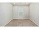 Empty bedroom with carpet, neutral paint, a window, and basic trim at 2000 N 36Th St # 17, Phoenix, AZ 85008