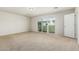 Spacious bedroom with neutral paint, carpet, and a sliding glass door to the outside at 2000 N 36Th St # 17, Phoenix, AZ 85008