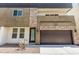 Contemporary two-story home featuring stone accents, a dark roof, and an integrated two-car garage at 2000 N 36Th St # 17, Phoenix, AZ 85008