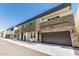 Modern townhome row featuring two-story facades with stone accents and attached two-car garages at 2000 N 36Th St # 17, Phoenix, AZ 85008