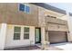 Modern two-story townhome with mixed material facade featuring stone and an attached two-car garage at 2000 N 36Th St # 17, Phoenix, AZ 85008