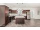 Spacious kitchen features dark cabinets, stainless steel appliances, island, and tile flooring at 2000 N 36Th St # 17, Phoenix, AZ 85008