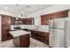 Well-lit kitchen features a center island, stainless steel appliances and dark wood cabinetry at 2000 N 36Th St # 17, Phoenix, AZ 85008