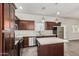 Beautiful kitchen showcasing dark cabinetry, stainless steel appliances, tile floors, and a center island at 2000 N 36Th St # 17, Phoenix, AZ 85008