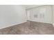 Bright living room with neutral walls, tiled floors, and large windows allowing ample natural light at 2000 N 36Th St # 17, Phoenix, AZ 85008