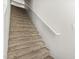 Carpeted staircase with a white handrail leading to the upper level of the home at 2000 N 36Th St # 17, Phoenix, AZ 85008