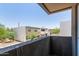 A balcony view that showcases modern architectural design, neutral tones, and a clear blue sky at 2000 N 36Th St # 20, Phoenix, AZ 85008