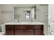 Bathroom featuring a double sink vanity with dark wood cabinets and modern faucets, and a shower-tub combo at 2000 N 36Th St # 20, Phoenix, AZ 85008