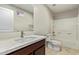 Bathroom featuring a single sink vanity, toilet, and shower-tub combination with white tile surround at 2000 N 36Th St # 20, Phoenix, AZ 85008