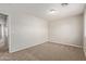 Spacious bedroom with neutral-colored walls, carpet flooring, and a doorway on the left at 2000 N 36Th St # 20, Phoenix, AZ 85008