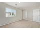 Neutral-colored bedroom featuring a window with blinds and carpet flooring at 2000 N 36Th St # 20, Phoenix, AZ 85008