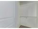 Bright walk-in closet with white walls, neutral carpet, and built-in shelving and rods for organization at 2000 N 36Th St # 20, Phoenix, AZ 85008