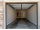 Spacious two-car garage with concrete floor, a water heater, and neutral-colored walls at 2000 N 36Th St # 20, Phoenix, AZ 85008