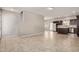 Open concept living room with tile floors leading to stairs and a kitchen at 2000 N 36Th St # 20, Phoenix, AZ 85008
