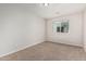 Neutral bedroom features plush carpet, window with natural light, and modern fixtures at 2000 N 36Th St # 35, Phoenix, AZ 85008