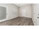 Neutral bedroom with wood floors, a window, and white doors at 2000 N 36Th St # 35, Phoenix, AZ 85008