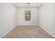 Neutral bedroom with window, carpet, and bright lighting for comfort and style at 2000 N 36Th St # 35, Phoenix, AZ 85008