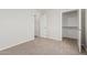 Cozy bedroom with plush carpet, closet, and entry door for convenience at 2000 N 36Th St # 35, Phoenix, AZ 85008