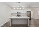 Modern kitchen features a large island, stainless appliances, and white cabinetry at 2000 N 36Th St # 35, Phoenix, AZ 85008