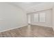 Bright living room with hardwood floors and two windows at 2000 N 36Th St # 35, Phoenix, AZ 85008