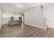 Open concept living space with hardwood floors and a partial kitchen view at 2000 N 36Th St # 35, Phoenix, AZ 85008