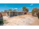 Backyard view of the property showing the covered porch and brick wall at 2331 E Delgado St, Phoenix, AZ 85022