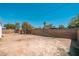 Large, sunny backyard area with dirt landscaping and brick perimeter wall at 2331 E Delgado St, Phoenix, AZ 85022