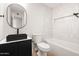 Modern bathroom featuring a sleek black sink, contemporary finishes, and bright white subway tile bathtub at 2331 E Delgado St, Phoenix, AZ 85022
