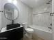 Sleek bathroom with black fixtures, modern vanity, and tiled shower/tub combo at 2331 E Delgado St, Phoenix, AZ 85022
