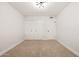 Bedroom with plush carpeting, modern light fixture, and bi-fold door closet for optimal storage at 2331 E Delgado St, Phoenix, AZ 85022