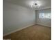 Cozy bedroom featuring plush carpet, a modern light fixture, and a window offering natural light at 2331 E Delgado St, Phoenix, AZ 85022