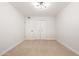 Comfortable bedroom featuring plush carpeting, a modern light fixture, and a closet for storage space at 2331 E Delgado St, Phoenix, AZ 85022