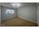 Bright bedroom featuring neutral paint, plush carpet, and a window offering natural light at 2331 E Delgado St, Phoenix, AZ 85022