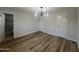 Bright bedroom with a modern chandelier, wood floors, and white trim at 2331 E Delgado St, Phoenix, AZ 85022