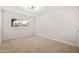 Bright bedroom with plush carpeting, a modern light fixture, and a large window with a view at 2331 E Delgado St, Phoenix, AZ 85022