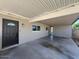 Exterior shot showcasing a covered carport and front entrance with modern accents at 2331 E Delgado St, Phoenix, AZ 85022