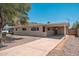 Exterior front view of home, driveway, carport, and manicured yard at 2331 E Delgado St, Phoenix, AZ 85022