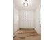 Hallway featuring wood-look floors and built-in storage and cabinets with doors that feature dark accents at 2331 E Delgado St, Phoenix, AZ 85022