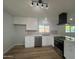 Renovated kitchen with stainless steel appliances, white cabinets, and quartz countertops at 2331 E Delgado St, Phoenix, AZ 85022