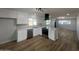Bright kitchen features white cabinets, stainless steel appliances, and stylish tile backsplash at 2331 E Delgado St, Phoenix, AZ 85022